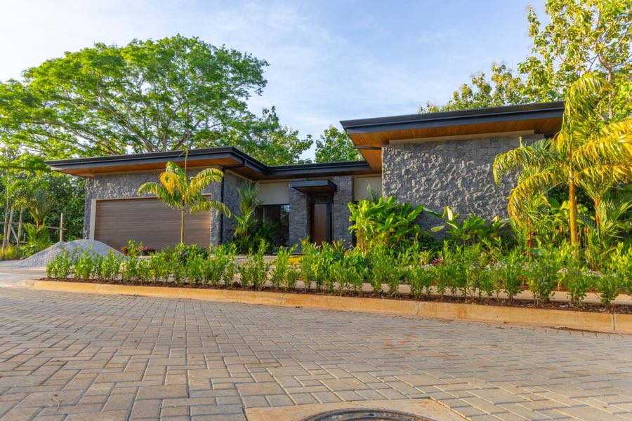 A completed residence with planting established